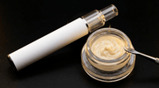 THCA live rosin vape pen beside a jar of pale golden whipped live rosin badder - Diesel Hemp
